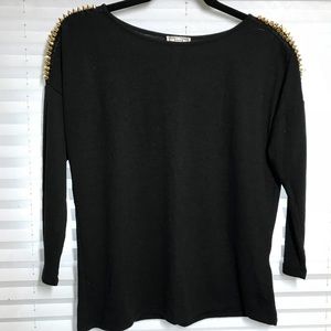 Black sweater with gold jems on shoulders